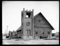 Presbyterian Church at Granger, WA., under construction. Building materials around church, other buildings in background.