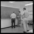 Faculty discussing physics in Weniger Hall, Fall 1962