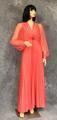 Evening gown of bright salmon pink polyester jersey with long chiffon sleeves