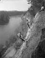 Climbers scaling cliff