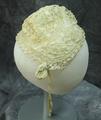Baby's night cap of ivory open-work crocheted lace with a lining of silk batiste