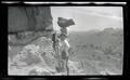 William L. Finley photographing a balancing rock
