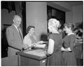 Participants in a president's summer session reception presenting their tickets; Memorial Union