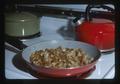 Fried potatoes in pan on stove, 1975