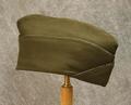WWII Army Garrison Cap of dark olive wool with navy and gold metal braided pipe trim