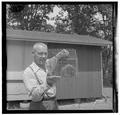 Forest mammologist Ed Hooven posing with a trapped rodent