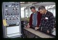 Russ Bonline and another looking at straw burner soil temperature experiment equipment, Oregon State University, Corvallis, Oregon, circa 1970