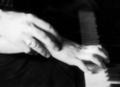 Hands of John Jacob Niles and Lyzette Engle, at piano