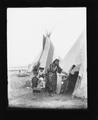 Woman with children at entrance to tipi
