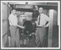 David Nicodemus and Richard Dempster, faculty members in the Physics Department, posing with the OSC cyclotron