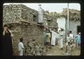 People building a house with bricks, Middle East, 1979