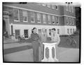 John Alexander posing outside of Commerce Hall with engineers visiting from Burma