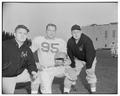 OSC assistant football coach Clay Stapleton, lineman John Witte, and an unidentified assistant coach