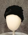 Hat of black silk velvet spiral pleated from the center crown continually to the base of the hat creating vertical-diagonal lines