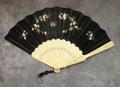 Folding fan of carved and punched ivory sticks