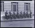 7 Portland policemen, on Harley-Davidson motorcycles. One officer standing next to them