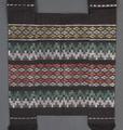 Satchel of black woven cotton with horizontal figured bands in white, green, rust, and yellow rayon floss