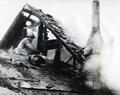 Fireman on roof of burning building