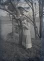 Wanda M. Gifford? standing next to a tree