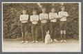The 1911 Freshmen wrestling team posing with Arbuthnot's dog