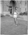 Promotional photo of an OSC co-ed watering grass with a garden hose