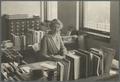 Lucy Lewis at her desk in the college library