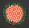 Roundel (looks like a coaster) of hot pink silk brocade with circle pattern of leaves in yellow and metallic threads