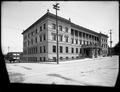 Portland City Hall from intersections of 5th and Madison St. Man leaning on wall in background.