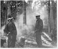 Three men standing in clearing with newly felled logs: Left Junior Hess (Engin SO), Center Verus Dahlin (DR), Right-clay Beal (Darlingtonia campground