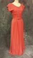 Dress of coral pink rayon crepe with scoop neckline and cap sleeves with sewn-in shoulder pads