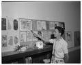 Virginia Taylor, staff artist in Publications Office, July 1958