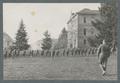 Cadets walking line abreast on lower campus, circa 1920