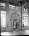 Interior of main entryway, US National Bank, Portland. Doorway flanked by drinking fountains set in columns.