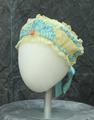 Headband of ivory lace with trim and accent of light blue satin ribbon