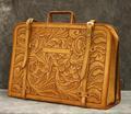 Attache briefcase of golden brown tooled leather in an Art Nouveau floral motif