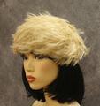 Cloche-style hat is fully embellished with blond feathers