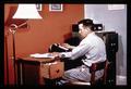 Farmer with desk calculator, circa 1965