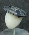 Saucer hat of navy blue straw with circular row pattern of white straw