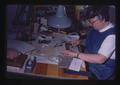 Woman at desk working with tools, Oregon, May 1974