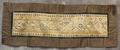 Table Runner of a solid embroidered center panel in ecru, gold, turquoise, light blue, medium blue, brown, rust, black, and lilac silk