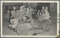Delta Zeta sorority sisters posing in an Army Jeep after finishing second in a war bond contest