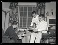 Gordon Wells (in wheelchair) posing in the living room of his fraternity