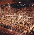 A large assembly at Gill Coliseum, perhaps for a concert