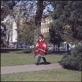 A student wears a sarape while walking on campus