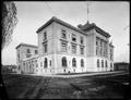 Portland Customs House, with two men on sidewalk at entrance.