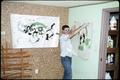 An OSU art student hangs his work