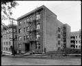 St. Clair Apartments on St. Clair St., Portland. Vacant lot next to building, street in foreground.