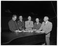 OSC faculty and administrators gathered around a piano in the Coliseum, October 26, 1954