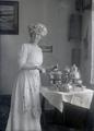 Rachel Morgan Gifford standing next to table with silver coffee service	