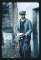 Farmer with bread at door of house, 1975